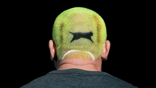 An enthusiastic tennis fan has his hair dyed the colour of a Slazenger ball on day one of the Wimbledon Tennis Championships in London, England on July 1, 2019. Tennis fans from all over the globe have descended on Wimbledon for the world-famous Grand Slam.