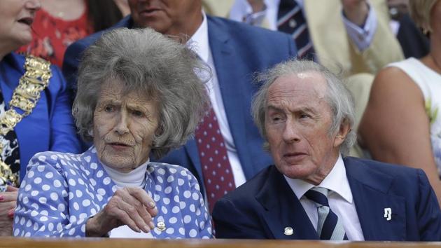 Former F1 world champion Sir Jackie Stewart and Victoria Stewart take their seats on Centre court on Monday. Big names packed the royal box on Day 1 but only one Royal family member, Prince Edward --who presents the trophy to winners every year-- was present and representing. The hotly anticipated tournament runs until July 14. (Kirsty Wigglesworth / AP)