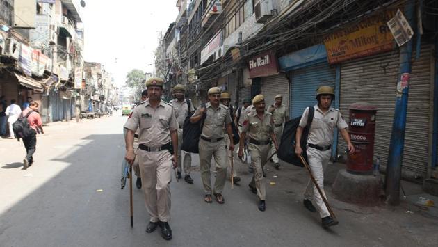A fight over parking a scooter snowballed into communal tension at Lal Kuan near Chawri Bazar in Old Delhi on Monday as groups of Hindu and Muslim residents accused each other of stone pelting and violence on Sunday night. There was heavy security with more than 1,000 Delhi Police and paramilitary personnel armed with anti-riot gear deployed through the day on Monday. (Sonu Mehta / HT Photo) A fight over parking a scooter snowballed into communal tension at Lal Kuan near Chawri Bazar in Old Delhi on Monday as groups of Hindu and Muslim residents accused each other of stone pelting and violence on Sunday night. There was heavy security with more than 1,000 Delhi Police and paramilitary personnel armed with anti-riot gear deployed through the day on Monday. (Sonu Mehta / HT Photo)
