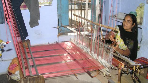 Weavers use kerosene for cleaning of silk yarn used in the Kota Doria fabric.(HT Photo)