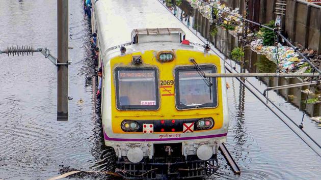 Mumbai: A suburban local train wades across submerged railway tracks following heavy monsoon rains, in Mumbai.(PTI)