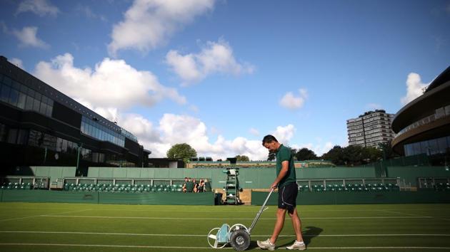 Groundstaff prepare the court before play. Britain’s summer burst of heat from across the continent ended being short-lived following a 34C Saturday in London. Cool air from Greenland is said to have plummeted temperatures to highs of 22C and cloudy skies just in time for the first serve. (Carl Recine / REUTERS)