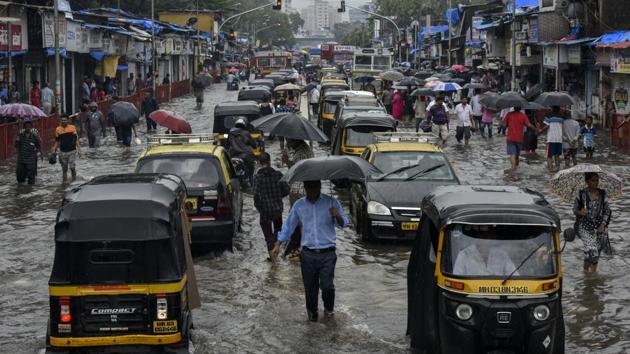 People walk along a flooded street after heavy rain showers outside the Kurla station, Mumbai, July 2, 2019 (Kunal Patil/HT Photo) People walk along a flooded street after heavy rain showers outside the Kurla station, Mumbai, July 2, 2019 (Kunal Patil/HT Photo)