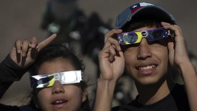 Children watch the solar eclipse from Puclaro, Coquimbo Region, Chile. President Sebastian Pinera said Chile was “the capital of the world in terms of astronomy, we are the eyes and the senses of humanity, being able to look, observe and study the stars and the Universe.” (Claudio Reyes / AFP)
