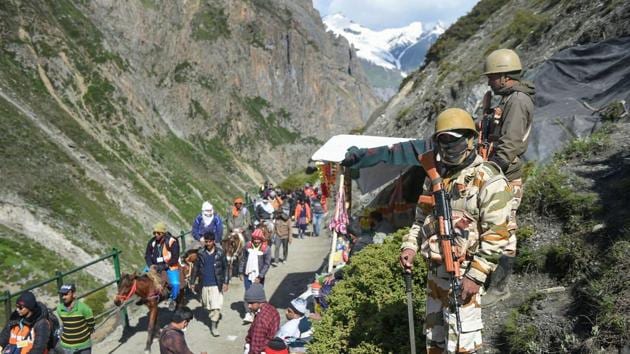 Security personnel stand guard as the first batch of pilgrims en route Amarnath passes them, at Baltal. The Amarnath cave is covered with snow most of the year except for a short period in summer when it is open for passage. Hindus worship a stalagmite inside the cave as an incarnation of Shiva, the Hindu god of destruction and regeneration. (S Irfan / PTI) Security personnel stand guard as the first batch of pilgrims en route Amarnath passes them, at Baltal. The Amarnath cave is covered with snow most of the year except for a short period in summer when it is open for passage. Hindus worship a stalagmite inside the cave as an incarnation of Shiva, the Hindu god of destruction and regeneration. (S Irfan / PTI)