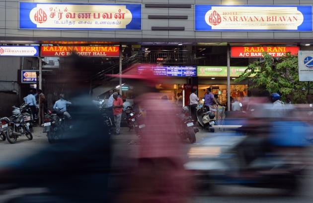 This photo taken on June 28, 2019 shows people outside a restaurant of the popular Saravana Bhavan food chain in Chennai. - Rajagopal's story has it all: rags to riches, the visionary creator of a trailblazing Indian restaurant chain -- and having a love rival murdered after some fateful cosmic advice.(AFP file photo)