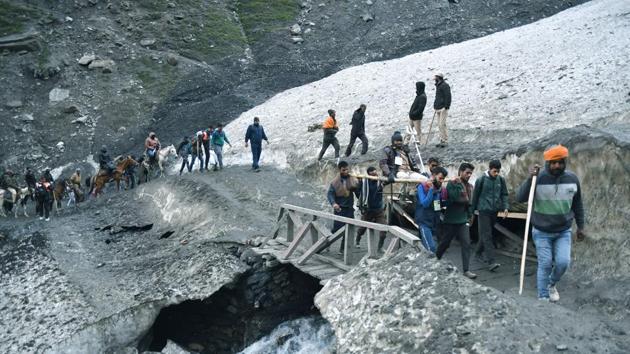 Pilgrims cross a mountain trail during their journey to the Amarnath shrine from the Baltal route. Over 1.5 lakh pilgrims from across the country have so far registered themselves for the pilgrimage which will conclude on August 15, a full-moon night that Hindus say commemorates Shiva revealing the secret of the creation of the universe. (ANI) Pilgrims cross a mountain trail during their journey to the Amarnath shrine from the Baltal route. Over 1.5 lakh pilgrims from across the country have so far registered themselves for the pilgrimage which will conclude on August 15, a full-moon night that Hindus say commemorates Shiva revealing the secret of the creation of the universe. (ANI)
