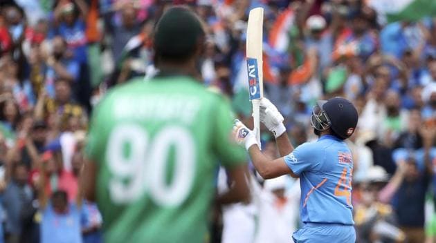 India's Rohit Sharma throws his bat in air to celebrate his century against Bangladesh.(AP)
