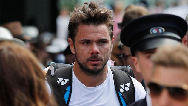 Switzerland's Stan Wawrinka (C) leaves court after losing his men's singles second round match.(AFP)