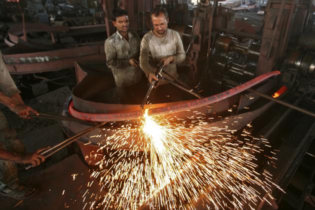 Labourers work inside an iron factory on the outskirts of Jammu. The deceleration in the real economy is coming at a time when economic sentiment is already stretched too thin.(Reuters)