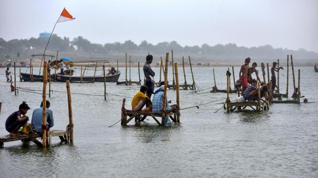 Fishermen in the Ganga at Prayagraj. A flood warning has been issued to 19 districts of Uttar Pradesh by the Flood Management Information System Centre (FMISC) this week, in view of the rise in river water level following heavy rain in Nepal. “The districts in the basin of Ganga, Ghagra and Sharda rivers have been issued a fresh alert after water level in these rivers crossed the danger mark,” said FMISC executive engineer Mithilesh Kumar. (PTI) Fishermen in the Ganga at Prayagraj. A flood warning has been issued to 19 districts of Uttar Pradesh by the Flood Management Information System Centre (FMISC) this week, in view of the rise in river water level following heavy rain in Nepal. “The districts in the basin of Ganga, Ghagra and Sharda rivers have been issued a fresh alert after water level in these rivers crossed the danger mark,” said FMISC executive engineer Mithilesh Kumar. (PTI)