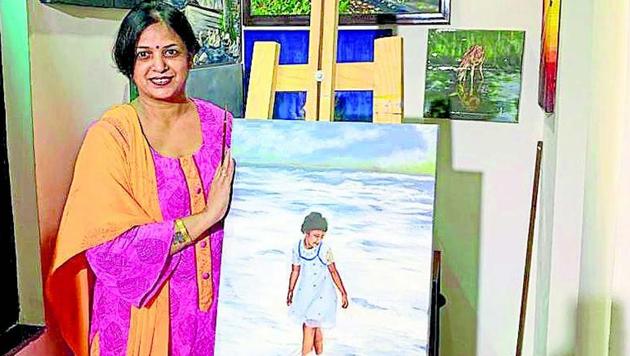 Sudha Sarawagi, 44, with her paintings at her residence in Sector 48.(Sourced)