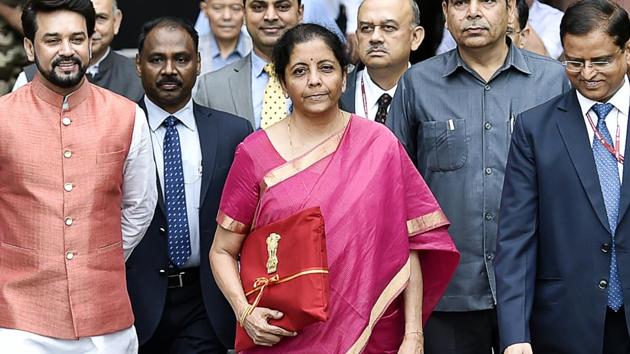 Minister of Finance Nirmala Sitharaman (C) seen holding the Budget folder--Bahi Katha wrapped in red cloth with the National Emblem. (Ajay Aggarwal/HT PHOTO) Minister of Finance Nirmala Sitharaman (C) seen holding the Budget folder--Bahi Katha wrapped in red cloth with the National Emblem. (Ajay Aggarwal/HT PHOTO)
