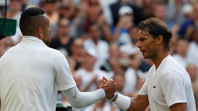 Spain's Rafael Nadal (R) shakes hands with Australia's Nick Kyrgios (L) after beating him in men's singles second round match at The All England Lawn Tennis Club in Wimbledon.(AFP)