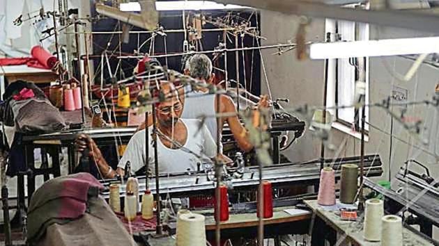 In this picture taken on September 25, 2017, Indian men work at a garment factory in Ludhiana. Over the last year India’s Prime Minister Narendra Modi has rolled out controversial, but many argue much-needed, flagship reforms -- often dubbed Modinomics -- designed to streamline Asia’s third largest economy and root out corruption. Economists had long argued such steps were vital if the country of 1.3 billion people is to continue creating jobs for its ever-growing population. But small traders -- who account for a third of the $2 trillion economy -- have been hit particularly hard. (AFP Photo) In this picture taken on September 25, 2017, Indian men work at a garment factory in Ludhiana. Over the last year India’s Prime Minister Narendra Modi has rolled out controversial, but many argue much-needed, flagship reforms -- often dubbed Modinomics -- designed to streamline Asia’s third largest economy and root out corruption. Economists had long argued such steps were vital if the country of 1.3 billion people is to continue creating jobs for its ever-growing population. But small traders -- who account for a third of the $2 trillion economy -- have been hit particularly hard. (AFP Photo)