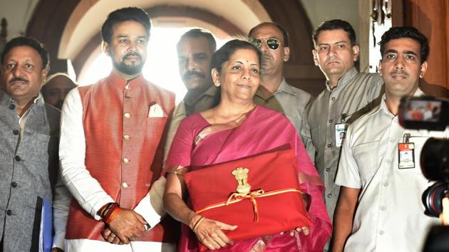 New Delhi, India - July 05, 2019: Minister of Finance Nirmala Sitharaman seen holding the Budget folder--Bahi Katha wrapped in red cloth with the National Emblem along with Minister of State in the Ministry of Finance Anurag Thakur upon their arrival to present the Union Budget 2019-20 in the Lok Sabha, at Parliament House, in New Delhi, India, on Friday, July 05, 2019. (Photo by Raj K Raj / Hindustan Times)(Raj K Raj/HT PHOTO)