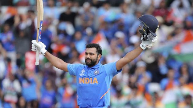 India's Rohit Sharma raises his bat and helmet to celebrate scoring a century.(AP)