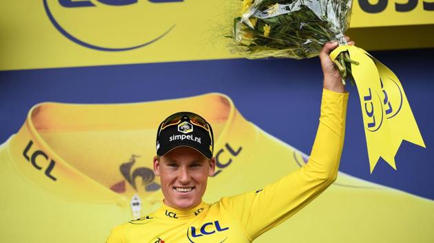 Dutch rider Mike Teunissen celebrates his overall leader’s yellow jersey on the podium of the first stage of the 106th edition of the Tour de France cycling race. (Anne-Christine Poujoulat / AFP) Dutch rider Mike Teunissen celebrates his overall leader’s yellow jersey on the podium of the first stage of the 106th edition of the Tour de France cycling race. (Anne-Christine Poujoulat / AFP)