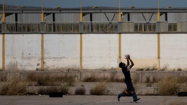 A man tries to catch the ball during a tape-ball cricket game in a disused parking lot for trucks in an industrial area in Elefsina. “I love cricket. I’m crazy for cricket. I’m 30 years old and I’m playing for 20 years,” said Awais Mughal, a delivery worker who arrived in Greece a decade ago. (Alkis Konstantinidis / REUTERS) A man tries to catch the ball during a tape-ball cricket game in a disused parking lot for trucks in an industrial area in Elefsina. “I love cricket. I’m crazy for cricket. I’m 30 years old and I’m playing for 20 years,” said Awais Mughal, a delivery worker who arrived in Greece a decade ago. (Alkis Konstantinidis / REUTERS)