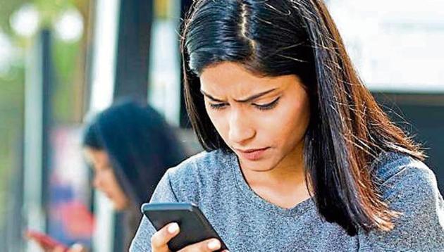 Beautiful woman holding drink can and text messaging on mobile phone Beautiful woman holding drink can and text messaging on mobile phone