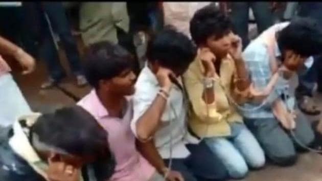 A video of the purported incident showed several villagers carrying sticks and forcing the alleged cattle-transporters to do sit-ups.(ANI Photo) A video of the purported incident showed several villagers carrying sticks and forcing the alleged cattle-transporters to do sit-ups.(ANI Photo)