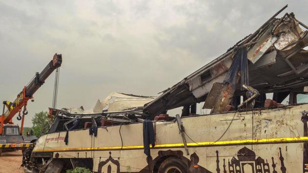 Mangled remains of a bus after it skidded off the six-lane Yamuna Expressway and fell into a large drain near Agra. 30 people have been killed in the mishap.(PTI)