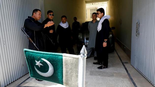 Pakistan's national flag attached to a vehicle is seen as armed guards, who provide security for Abdul Khaliq Hazara, politician and chairman of the Hazara Democratic Party (HDP), chat with each other at his residence. Soldiers and security checkpoints greet visitors to Hazara town, one of two large guarded neighbourhoods in the capital of Baluchistan, a province where religious and sectarian groups often target the mostly Shia Hazaras with bombs and guns. (Akhtar Soomro / REUTERS) Pakistan's national flag attached to a vehicle is seen as armed guards, who provide security for Abdul Khaliq Hazara, politician and chairman of the Hazara Democratic Party (HDP), chat with each other at his residence. Soldiers and security checkpoints greet visitors to Hazara town, one of two large guarded neighbourhoods in the capital of Baluchistan, a province where religious and sectarian groups often target the mostly Shia Hazaras with bombs and guns. (Akhtar Soomro / REUTERS)