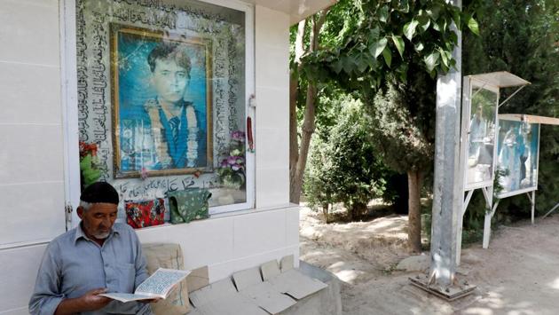 A Hazara man reads the Koran along a passageway with photos of deceased victims who lost their lives during bomb attacks, at the graveyard. Despite improved security in recent years, partly because most Hazaras have moved into the guarded enclaves, hardline Sunni militants keep up attacks, such as a blast in April that killed 24 people, among them eight Hazaras. (Akhtar Soomro / REUTERS) A Hazara man reads the Koran along a passageway with photos of deceased victims who lost their lives during bomb attacks, at the graveyard. Despite improved security in recent years, partly because most Hazaras have moved into the guarded enclaves, hardline Sunni militants keep up attacks, such as a blast in April that killed 24 people, among them eight Hazaras. (Akhtar Soomro / REUTERS)