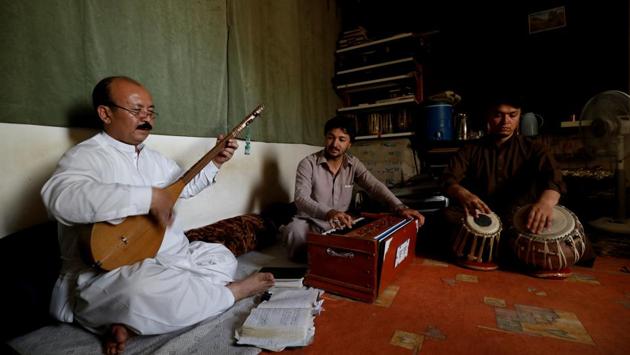 Mir Hussain Changazi (L) from Hazara community plays Hazargi instrument Damboora, as he sings traditional songs along with Fida Hussain playing Harmonium and Zia Noorband on Tabla, as they practice at Aahanga musical academy. (Akhtar Soomro / REUTERS) Mir Hussain Changazi (L) from Hazara community plays Hazargi instrument Damboora, as he sings traditional songs along with Fida Hussain playing Harmonium and Zia Noorband on Tabla, as they practice at Aahanga musical academy. (Akhtar Soomro / REUTERS)