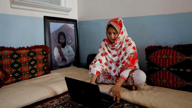 Nargis Hazara, 20, martial arts specialist, works on her computer as she sits beside her portrait at her home. Domestic media often portray the Hazaras as targets of sectarian attacks or holding sit-ins to demand greater protection, but the community is developing and growing, said Nargis, who last year became Pakistan’s first winner of an Asian Games medal in karate. (Akhtar Soomro / REUTERS) Nargis Hazara, 20, martial arts specialist, works on her computer as she sits beside her portrait at her home. Domestic media often portray the Hazaras as targets of sectarian attacks or holding sit-ins to demand greater protection, but the community is developing and growing, said Nargis, who last year became Pakistan’s first winner of an Asian Games medal in karate. (Akhtar Soomro / REUTERS)