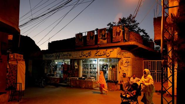 Resident walk past a shop during sunset hours along a street in Mariabad. Many community businesses that flourished in Quetta’s bustling wholesale markets have shuttered and relocated to Hazara Town or Mari Abad, another Hazara neighbourhood. But the community is defiant. Some still venture out into Quetta in search of work, while others keep businesses running. (Akhtar Soomro / REUTERS) Resident walk past a shop during sunset hours along a street in Mariabad. Many community businesses that flourished in Quetta’s bustling wholesale markets have shuttered and relocated to Hazara Town or Mari Abad, another Hazara neighbourhood. But the community is defiant. Some still venture out into Quetta in search of work, while others keep businesses running. (Akhtar Soomro / REUTERS)
