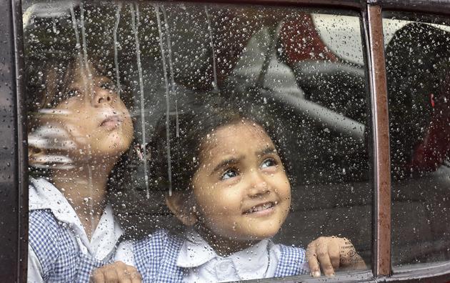 Children look through the window of a school van as it rains in the national capital in New Delhi. Though there was a dip in the mercury level, the humidity was high on Tuesday morning, at 68 per cent. According to private forecaster Skymet, heavy rains were expected over Mumbai, West Bengal and Uttar Pradesh. (Raj K Raj / HT Photo) Children look through the window of a school van as it rains in the national capital in New Delhi. Though there was a dip in the mercury level, the humidity was high on Tuesday morning, at 68 per cent. According to private forecaster Skymet, heavy rains were expected over Mumbai, West Bengal and Uttar Pradesh. (Raj K Raj / HT Photo)