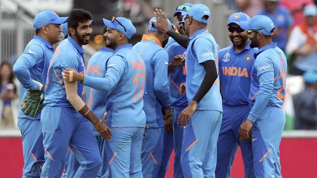 Jasprit Bumrah, second left, celebrates with teammates the dismissal of New Zealand's Martin Guptill.(AP)