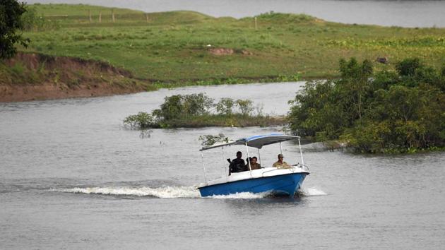 Forest guards patrol on a speedboat on Diphlu river in Kaziranga National Park. They are on duty constantly for weeks at a time in this period, sometimes sleeping out in the open -- must follow the animals to protect them from harm. “We really feel bad when something bad like poaching happens to the animals,” says ranger Manoj Gogoi. (Biju Boro / AFP) 