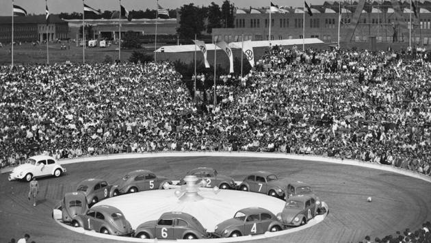 To celebrate the 500,000 produced Volkswagen Beetle after WW II, the company had organised a beetle roulette, with 10 red and green beetles in the Volkswagen stadium in Wolfsburg, West Germany, on July 7, 1953. The car was a symbol of Germany’s postwar economic renaissance and rising middle-class prosperity. (Henry Brueggemann / AP) To celebrate the 500,000 produced Volkswagen Beetle after WW II, the company had organised a beetle roulette, with 10 red and green beetles in the Volkswagen stadium in Wolfsburg, West Germany, on July 7, 1953. The car was a symbol of Germany’s postwar economic renaissance and rising middle-class prosperity. (Henry Brueggemann / AP)