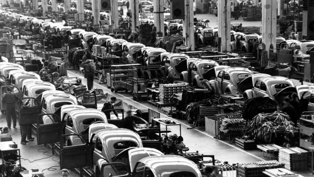 Volkswagen beetles are assembled in lines at the Volkwagen auto works plant, which manufactures nearly 900 automobiles each day, in Wolfsburg, West Germany, on June 16, 1954. Thanks to Volkswagen, Wolfsburg boomed in West Germany’s postwar rebirth and today the town and the company are inseparable. By 1955, the one millionth Beetle - officially called the Type 1 - had rolled off the assembly line in Wolfsburg. (Albert Riethausen / AP) Volkswagen beetles are assembled in lines at the Volkwagen auto works plant, which manufactures nearly 900 automobiles each day, in Wolfsburg, West Germany, on June 16, 1954. Thanks to Volkswagen, Wolfsburg boomed in West Germany’s postwar rebirth and today the town and the company are inseparable. By 1955, the one millionth Beetle - officially called the Type 1 - had rolled off the assembly line in Wolfsburg. (Albert Riethausen / AP)