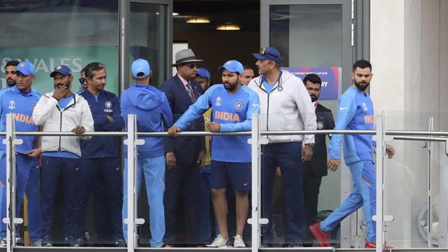 India's captain Virat Kohli, right, stands in the pavilion with teammates.(AP)