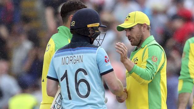 England's captain Eoin Morgan, left, shakes hands with Australia's captain Aaron Finch. (AP)