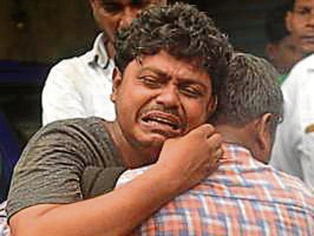 Family members of a 1.5 year old boy falls into open drain at Ambedkar Nagar in Goregaon east.The operation began late night on Wednesday and continued till next day morning in Mumbai on Thursday. ((Photo by Satyabrata Tripathy/Hindustan Times)) Family members of a 1.5 year old boy falls into open drain at Ambedkar Nagar in Goregaon east.The operation began late night on Wednesday and continued till next day morning in Mumbai on Thursday. ((Photo by Satyabrata Tripathy/Hindustan Times))
