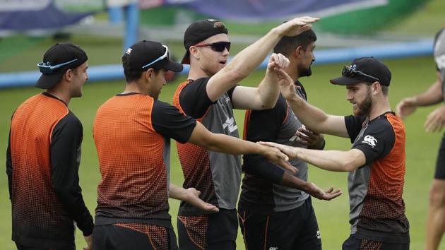 New Zealand's captain Kane Williamson, right, high-fives his teammates during a practice session.(AP)
