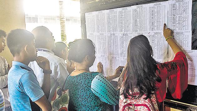 Students and parents check the first merit list last year.(HT file)