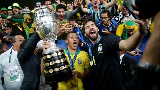 Brazil’s Richarlison and Alisson celebrate after winning the Copa America with the trophy, at Maracana Stadium, in Rio de Janeiro, Brazil. (Ricardo Moraes / REUTERS)