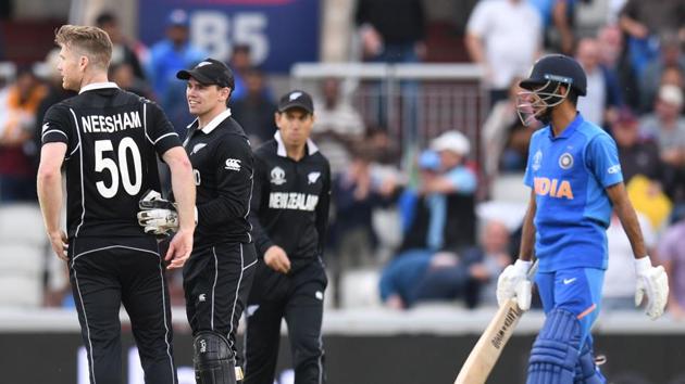 New Zealand's James Neesham (L) celebrates with New Zealand's Tom Latham after taking the final wicket of India's Yuzvendra Chahal and winning the 2019 Cricket World Cup first semi-final between New Zealand and India at Old Trafford in Manchester, northwest England, on July 10, 2019. (Photo by Oli SCARFF / AFP) / RESTRICTED TO EDITORIAL USE(AFP)