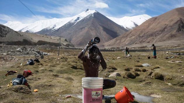 Chota Montu, 25, takes a bath on his day off at his campsite. Sundays are the only days they can do their laundry as well as bathe and shave. (Xavier Galiana / AFP) Chota Montu, 25, takes a bath on his day off at his campsite. Sundays are the only days they can do their laundry as well as bathe and shave. (Xavier Galiana / AFP)
