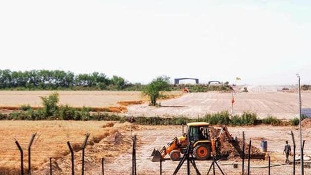 Heavy machines at work beyond the border fence for the construction of the Indian side of Kartarpur corridor, in Gurdaspur district. India is building a four-lane highway on the Indian side. It connects to the zero point of the corridor up to NH 354.(PTI)