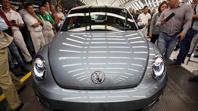 A Volkswagen “Beetle”, the final edition of the iconic car, is seen inside the factory in Puebla, Puebla State, Mexico. The bug-shaped metallic blue sedan rolled off the production line in central Mexico to rapturous applause, the last of a model first manufactured in the late 1930s. (Juan Carlos Sanchez / AFP)