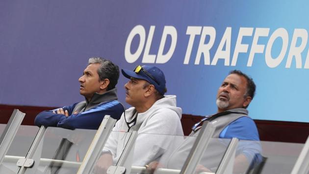 Indian team coaching staff, from left, assistant coach Sanjay Bangar, head coach Ravi Shastri and bowling coach Bharat Arun stand outside their dressing room before the Cricket World Cup semi-final match between India and New Zealand was suspended for the day due to rains at Old Trafford in Manchester, England, Tuesday, July 9, 2019.(AP) Indian team coaching staff, from left, assistant coach Sanjay Bangar, head coach Ravi Shastri and bowling coach Bharat Arun stand outside their dressing room before the Cricket World Cup semi-final match between India and New Zealand was suspended for the day due to rains at Old Trafford in Manchester, England, Tuesday, July 9, 2019.(AP)