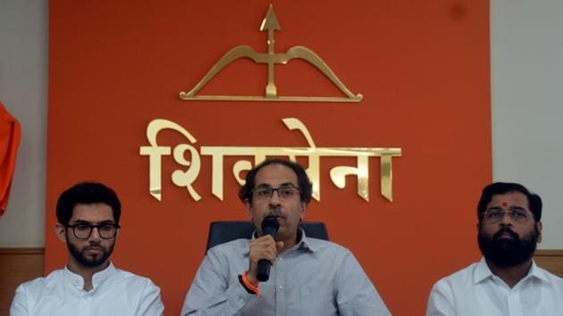 Shiv Sena chief Uddhav Thackeray with his son Aaditya (left) and leader Eknath Shinde at Sena Bhavan in Mumbai on Thursday.(BHUSHAN KOYANDE/HT)