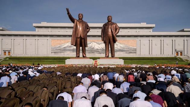 People bow before the statues of the late North Korean leaders Kim II Sung and Kim Jong II as the country marks the 25th death anniversary of Kim II Sung, at Mansu Hill in Pyongyang, North Korea. (Kim Won Jin / AFP)
