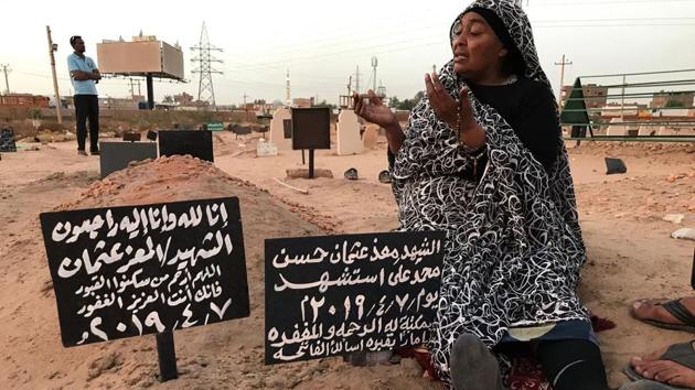 Khadom, the mother of Al-Moez visits the tomb of her son, killed when a bullet pierced the window of his workplace and lodged itself in his heart during an anti-government demonstration in the Sudanese capital Khartoum in April. Like dozens of others who lost a son, uncle or brother, Al-Moez’ family has paid a high price for Sudan’s revolution that toppled its longtime autocratic ruler Omar al-Bashir in April. (Claire Doyen / AFP)